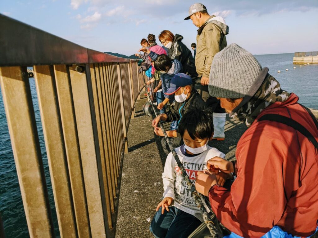 ロープにわかめの種糸をまきつける菅島小学校児童たち
